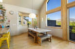 This stunning dining area boasts a rustic wooden table and benches, perfect for family gatherings.