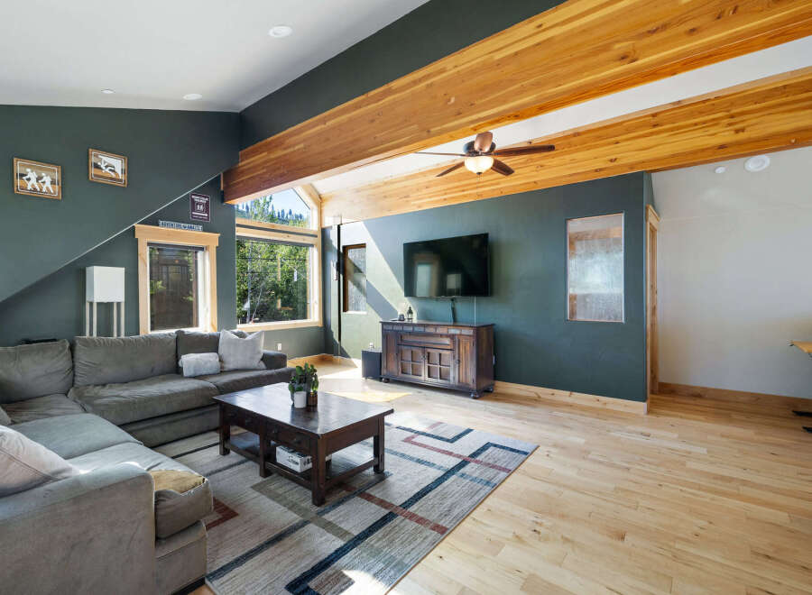 Step into this stunning living space, boasting a cozy sectional sofa and a rustic coffee table, perfect for gatherings.