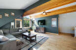 Step into this stunning living space, boasting a cozy sectional sofa and a rustic coffee table, perfect for gatherings.