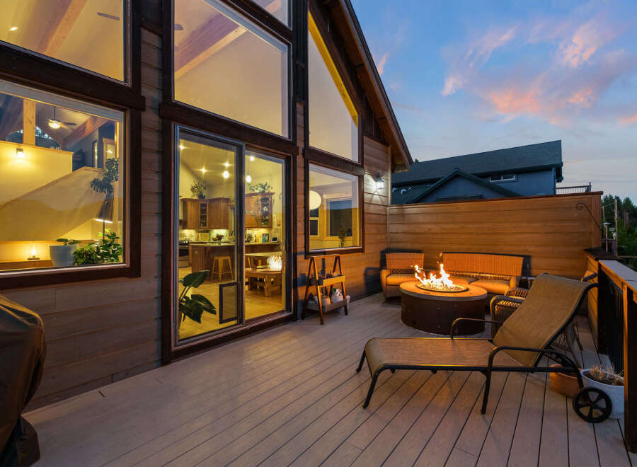 Experience luxury living in this stunning property featuring a spacious deck with a cozy fire pit, perfect for evening gatherings.