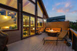 Experience luxury living in this stunning property featuring a spacious deck with a cozy fire pit, perfect for evening gatherings.