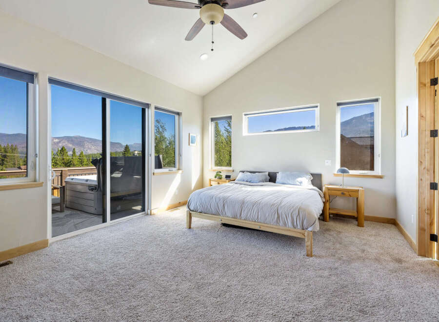 Experience luxury living in this stunning bedroom with breathtaking mountain views.