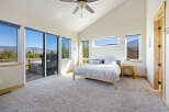 Experience luxury living in this stunning bedroom with breathtaking mountain views.