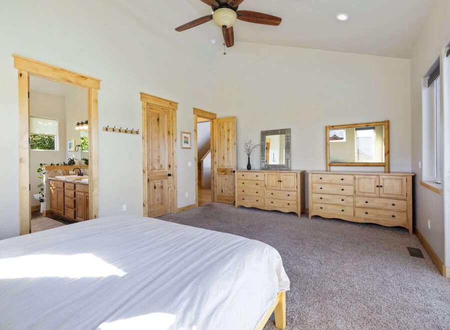 Step into this spacious bedroom, featuring a serene ambiance and ample natural light.