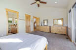 Step into this spacious bedroom, featuring a serene ambiance and ample natural light.