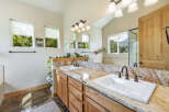 Step into luxury with this stunning bathroom featuring a double vanity with a beautiful granite countertop.