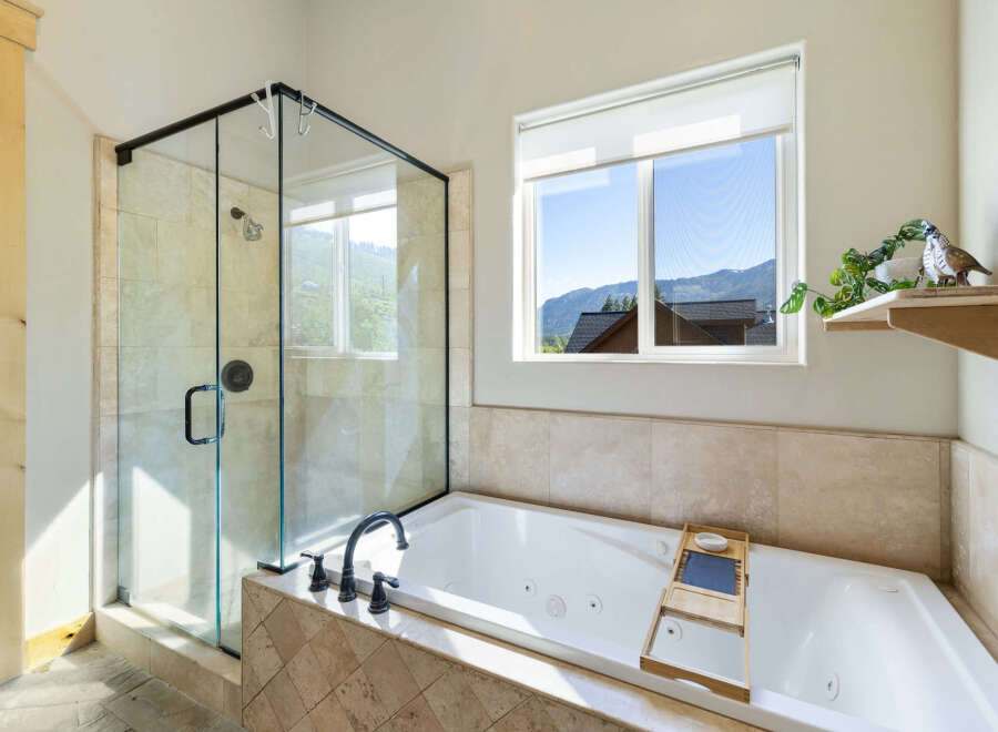 Enjoy the luxury of this stunning bathroom featuring a modern glass shower and a relaxing jacuzzi tub.