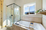 Enjoy the luxury of this stunning bathroom featuring a modern glass shower and a relaxing jacuzzi tub.