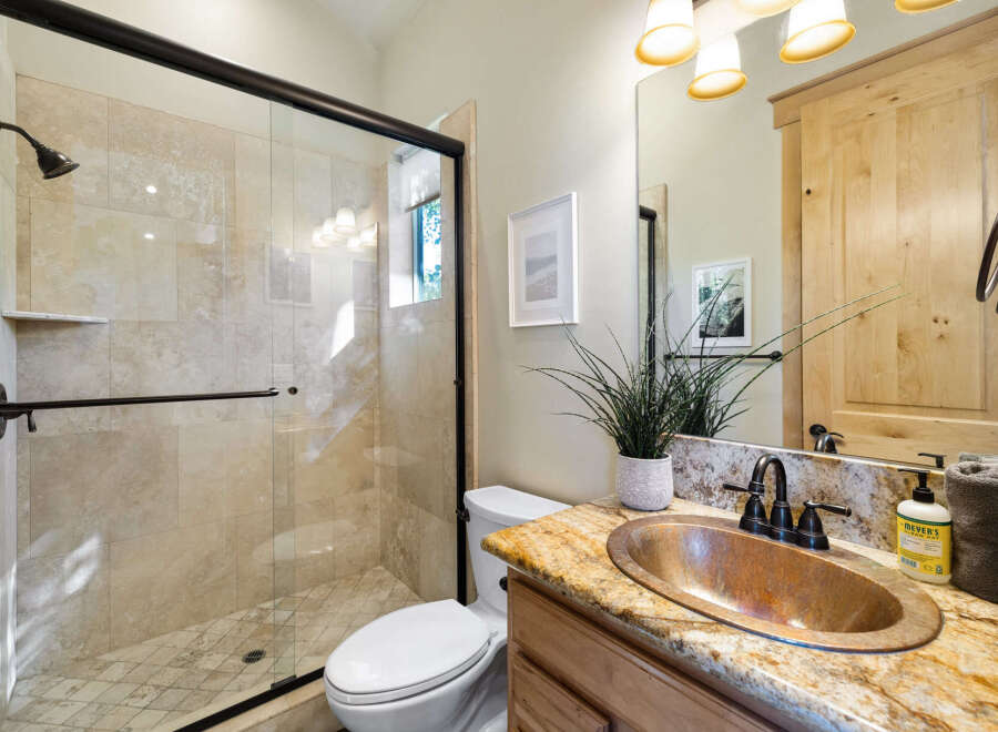 Step into luxury with this stunning bathroom! Featuring a beautiful copper sink, a spacious walk-in shower, and elegant tile work, this space is designed for both style and functionality.
