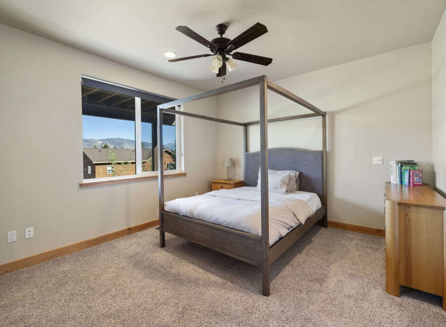 Step into this inviting bedroom, featuring a stylish four-poster bed and a serene ambiance.