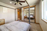 Step into this inviting bedroom, featuring a stylish canopy bed and ample natural light.