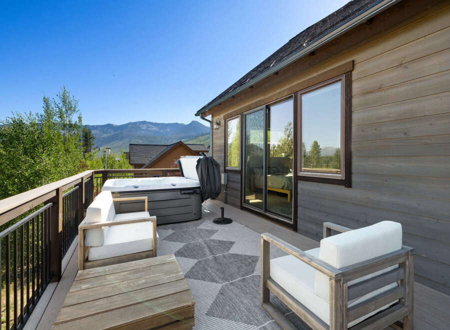 Enjoy breathtaking mountain views from this stunning property featuring a luxurious hot tub and a spacious deck.