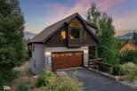 Discover the charm of this stunning mountain home, featuring a spacious garage and a beautifully designed exterior.