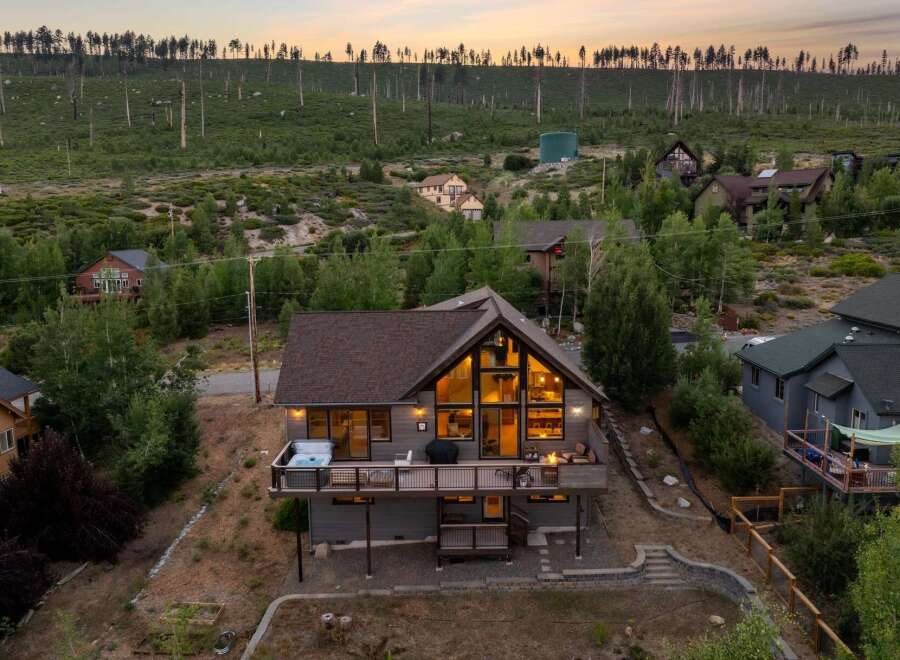 Escape to your dream mountain retreat! This stunning home boasts a spacious deck with a hot tub, perfect for relaxing and enjoying the breathtaking views.