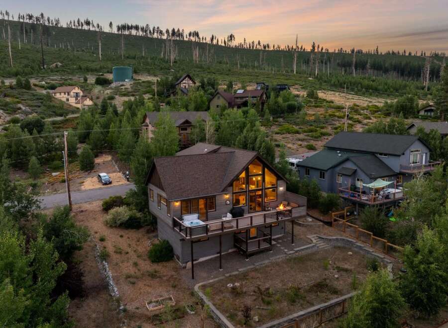 Discover your dream mountain retreat! This stunning home boasts a spacious deck with a hot tub, perfect for enjoying breathtaking views.