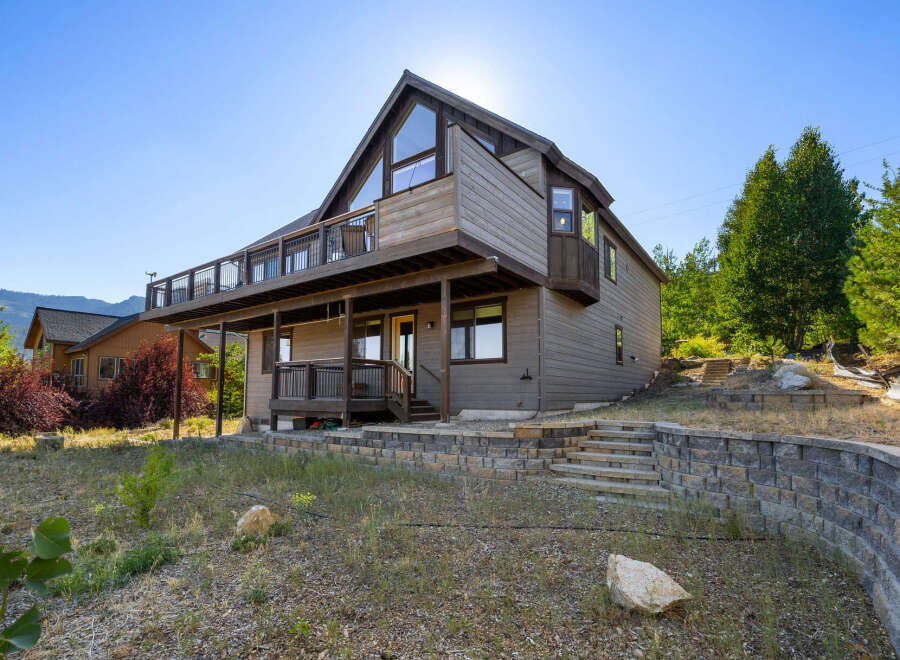 This stunning property boasts a modern design with a spacious deck, perfect for enjoying the scenic views.