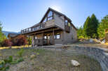This stunning property boasts a modern design with a spacious deck, perfect for enjoying the scenic views.