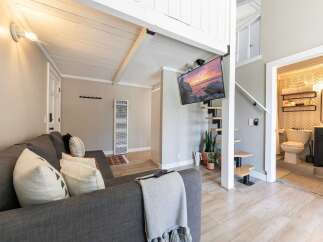 Discover this charming property featuring a cozy living area with a comfortable sofa and stylish decor.
