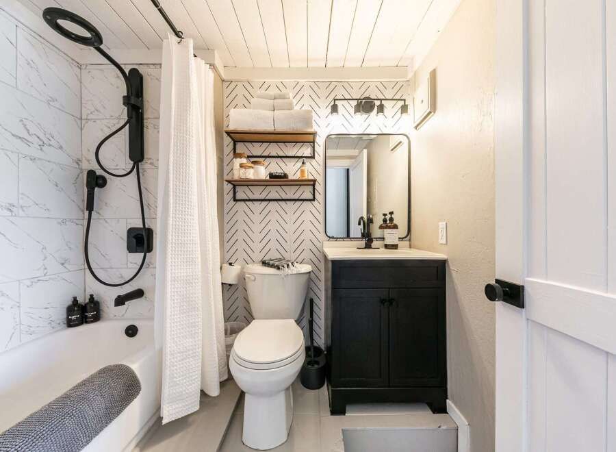 Step into this beautifully designed bathroom, featuring a modern aesthetic with a touch of farmhouse charm.