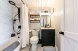 Step into this beautifully designed bathroom, featuring a modern aesthetic with a touch of farmhouse charm.