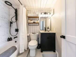 Step into this beautifully designed bathroom, featuring a modern aesthetic with a touch of farmhouse charm.