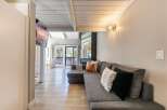 This stunning property boasts a modern living space with a comfortable sectional sofa and stylish accent pillows.