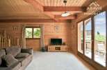 Discover the charm of this stunning property, featuring a warm and inviting interior with beautiful wooden walls and ceilings.