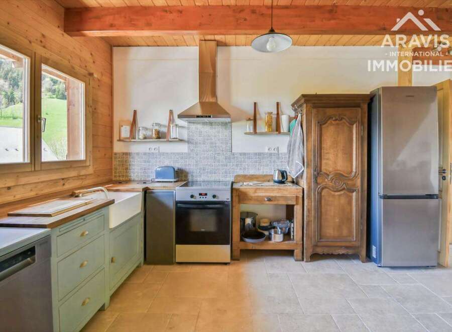 This charming kitchen boasts a rustic aesthetic with its wooden cabinetry and exposed beams.