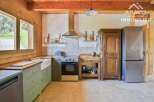 This charming kitchen boasts a rustic aesthetic with its wooden cabinetry and exposed beams.