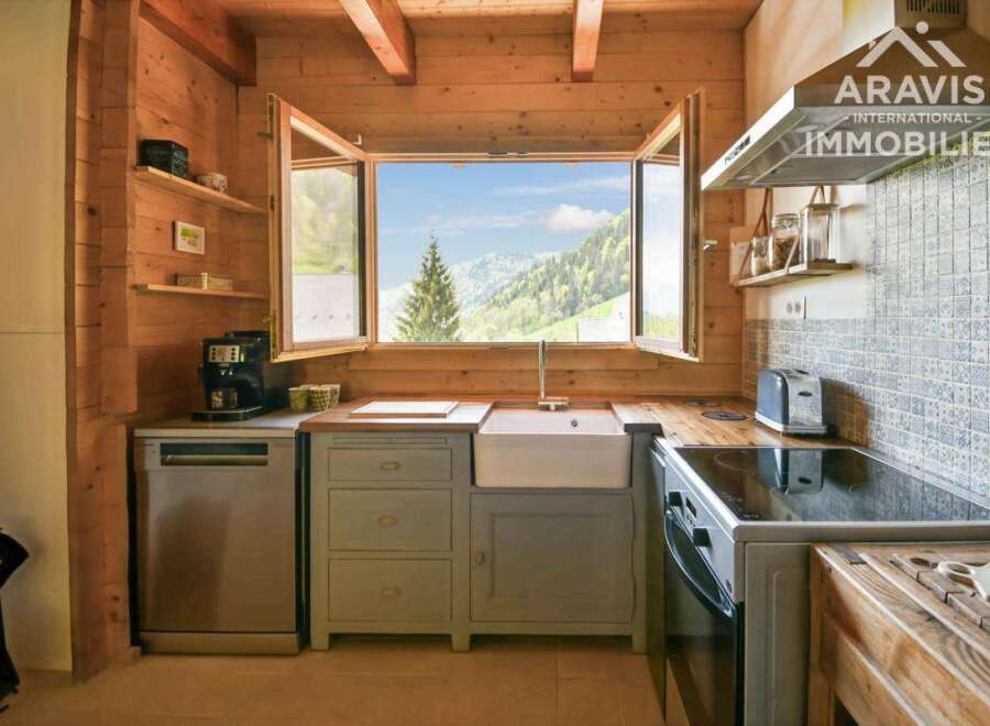 Discover the charm of this stunning kitchen, featuring a bright and airy design with a breathtaking mountain view.