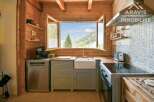 Discover the charm of this stunning kitchen, featuring a bright and airy design with a breathtaking mountain view.