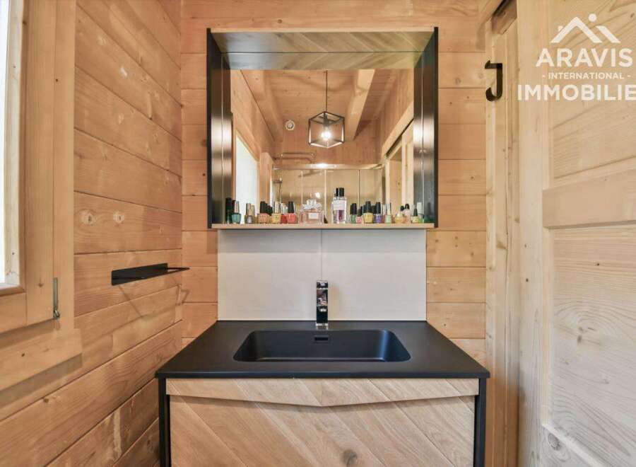 Discover the charm of this beautifully designed bathroom, featuring natural wood paneling that exudes warmth and character.