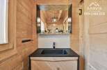Discover the charm of this beautifully designed bathroom, featuring natural wood paneling that exudes warmth and character.