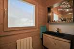 Discover this charming bathroom featuring a stylish black sink and a beautifully designed wooden vanity.