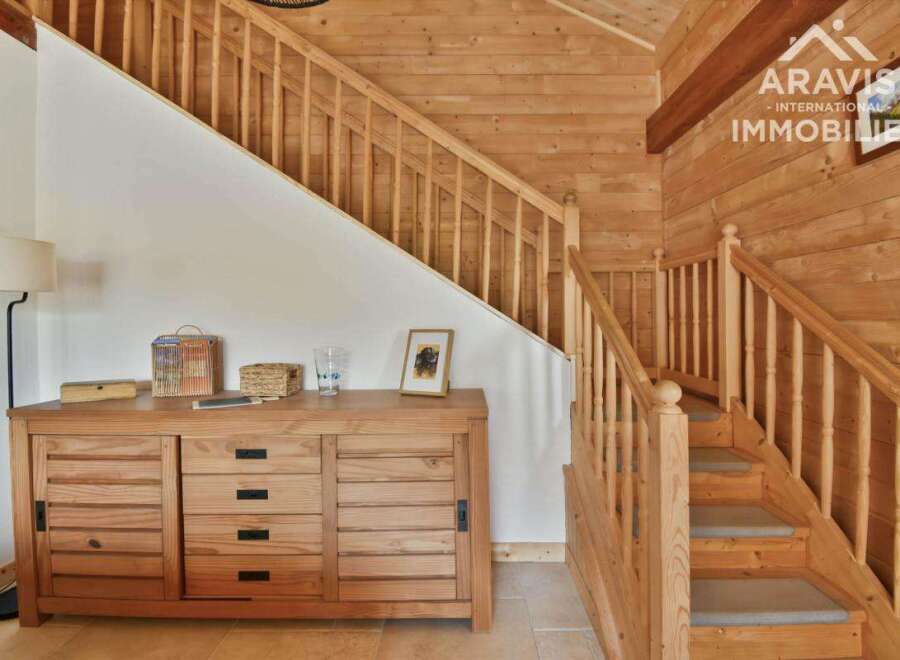 Discover the charm of this stunning property featuring a beautifully crafted wooden staircase and a warm, inviting interior.