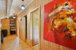 Discover this stunning property featuring a warm and inviting interior with wooden paneling throughout.