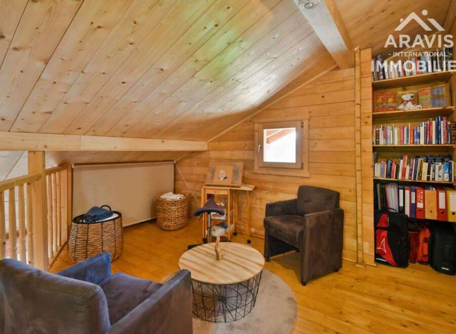 Discover the charm of this cozy attic space, perfect for a home office or relaxation area.