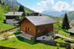 Discover a charming wooden chalet nestled in a picturesque mountain setting.