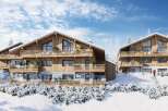 Discover the charm of these stunning wooden chalets nestled in a snowy landscape.