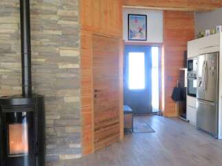 Step into this inviting home featuring a cozy fireplace and a stylish kitchen.