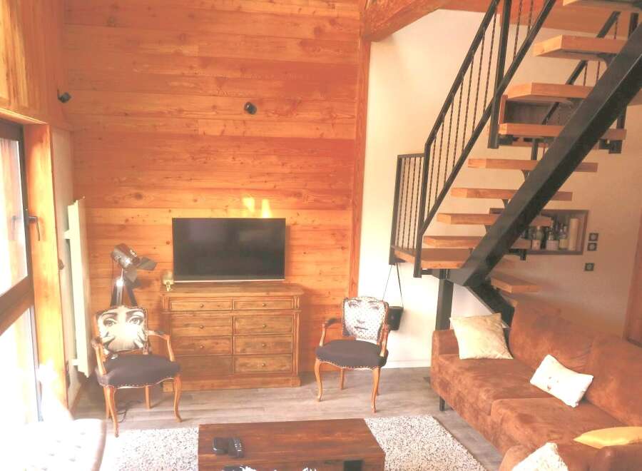 This stunning property boasts a warm and inviting living space, featuring beautiful wooden accents throughout.