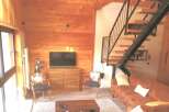 This stunning property boasts a warm and inviting living space, featuring beautiful wooden accents throughout.