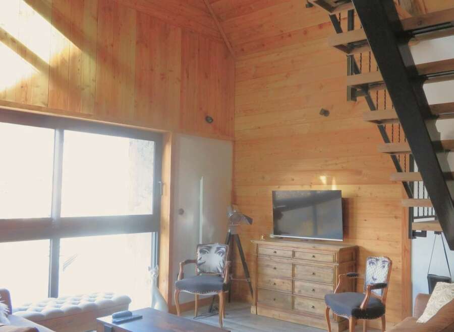 Step into this stunning property featuring a unique wooden interior and a modern staircase.