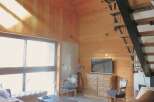Step into this stunning property featuring a unique wooden interior and a modern staircase.