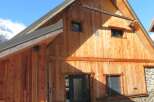 This stunning wooden cabin offers a warm and inviting atmosphere, perfect for a mountain retreat.