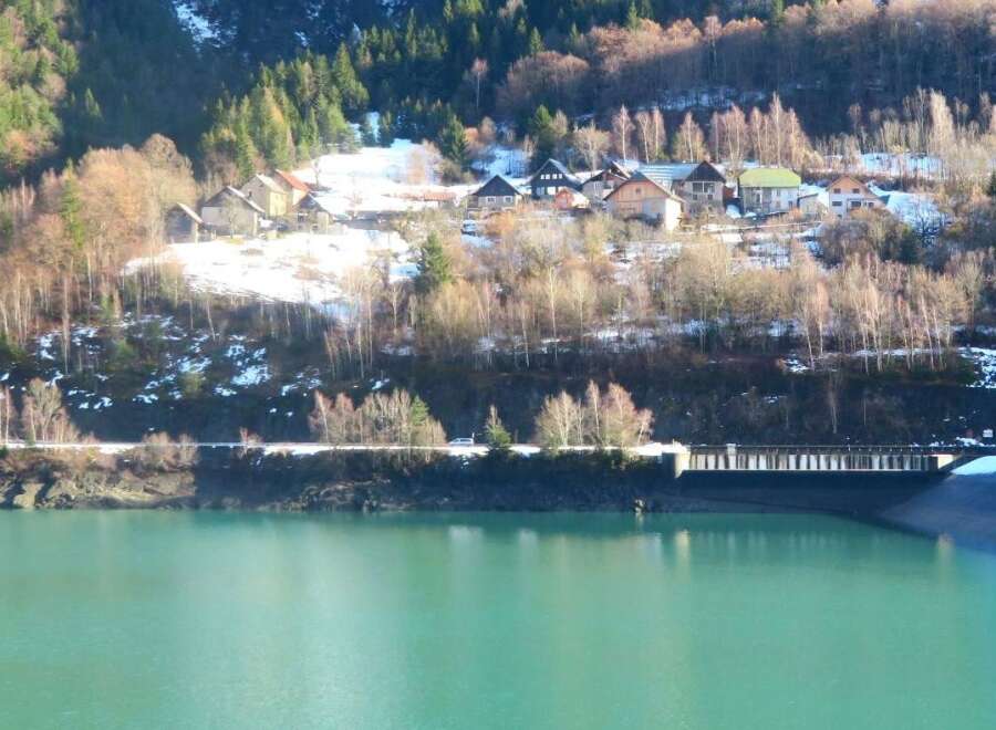 Nestled in a picturesque mountain setting, this property offers stunning views of the surrounding landscape and a serene lake.