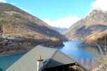 Discover breathtaking views from this stunning property! Nestled in a picturesque valley, this home offers unparalleled access to a serene lake and majestic mountains.