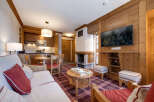 Experience the warmth of this charming apartment, featuring a cozy living area with a fireplace and a modern kitchen.