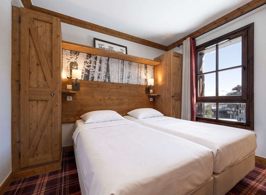 Experience the charm of this cozy bedroom featuring two comfortable beds, perfect for a relaxing stay.