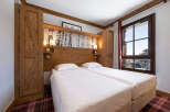 Experience the charm of this cozy bedroom featuring two comfortable beds, perfect for a relaxing stay.